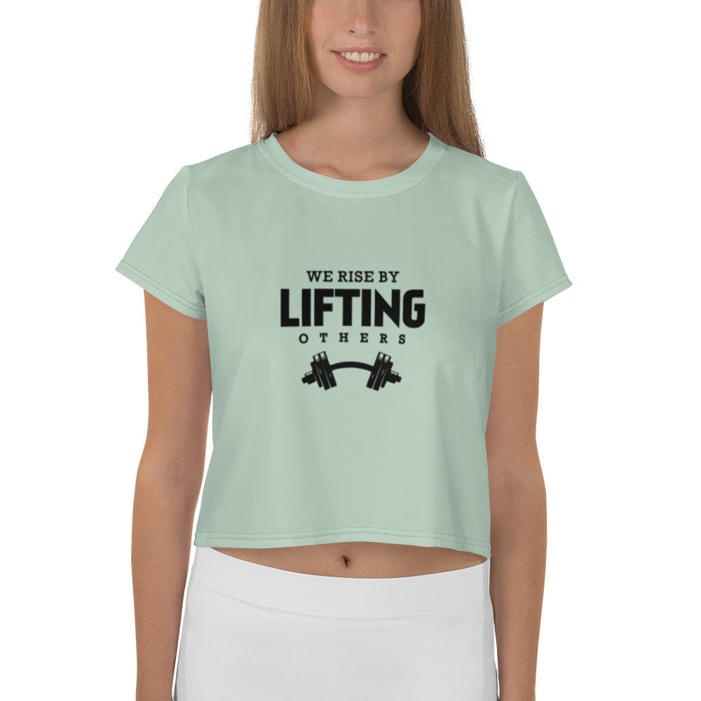 WE RISE BY LIFTING OTHERS - All-Over Print Crop Tee