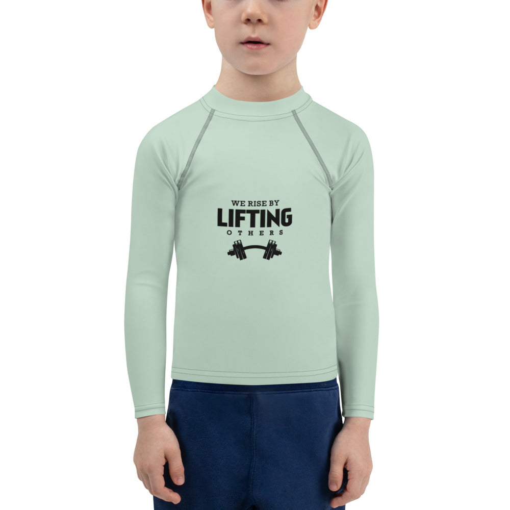 WE RISE BY LIFTING OTHERS - Kids Rash Guard