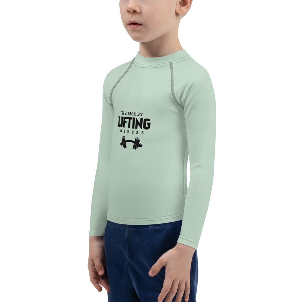 WE RISE BY LIFTING OTHERS - Kids Rash Guard