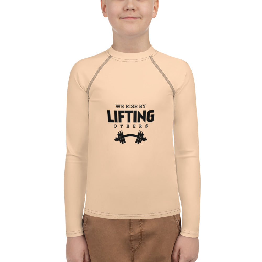 WE RISE BY LIFTING OTHERS - Youth Rash Guard