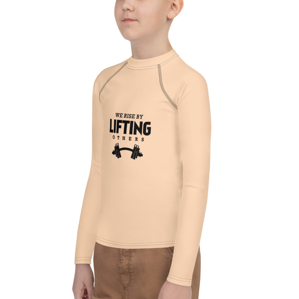 WE RISE BY LIFTING OTHERS - Youth Rash Guard